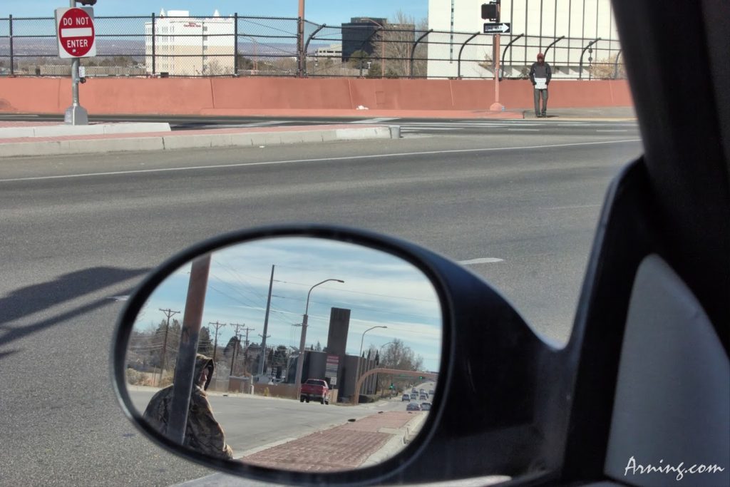 Poverty - two guys working the interchange exit.